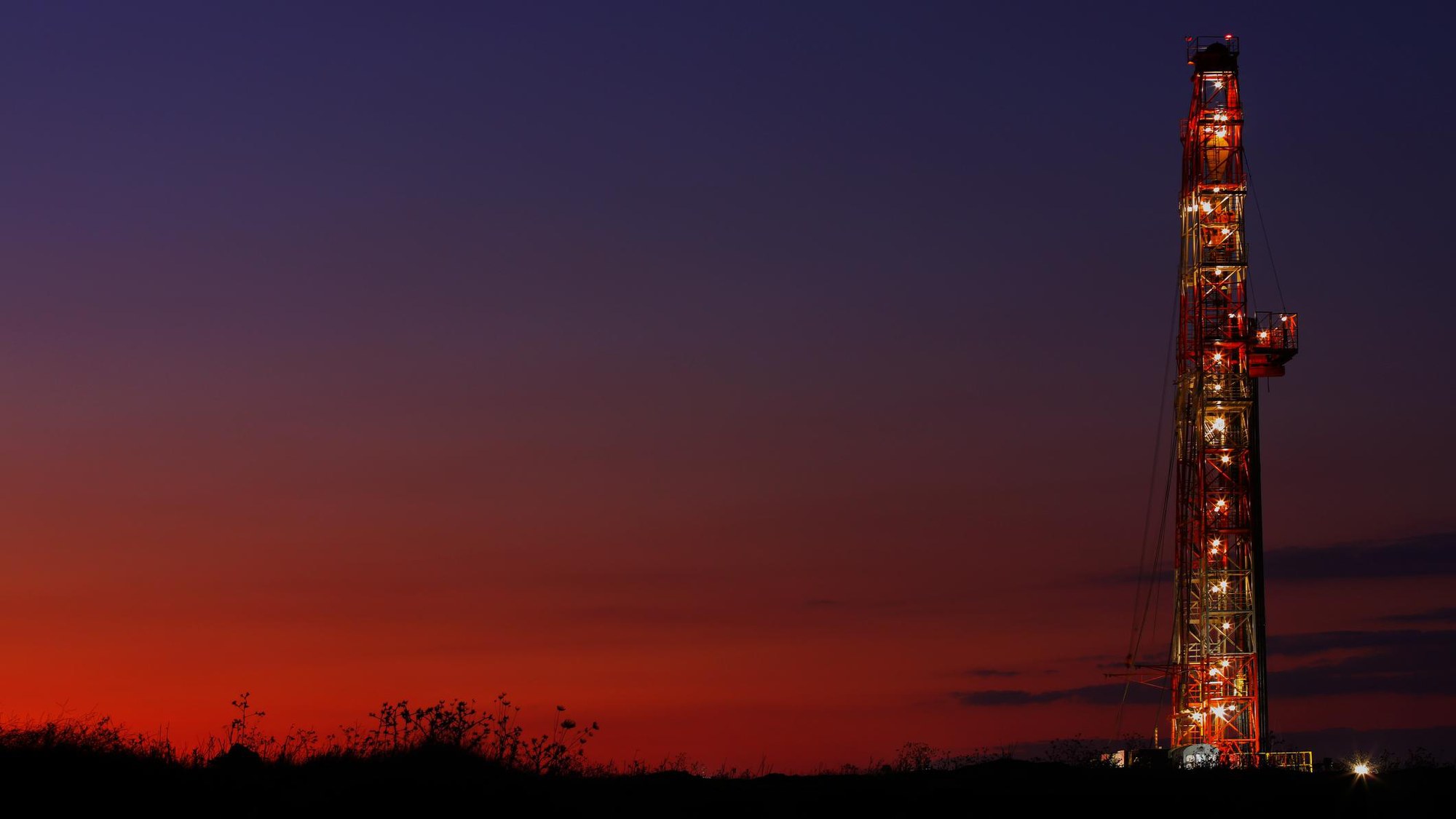 Drilling rig at dusk flying the Brazilian flag